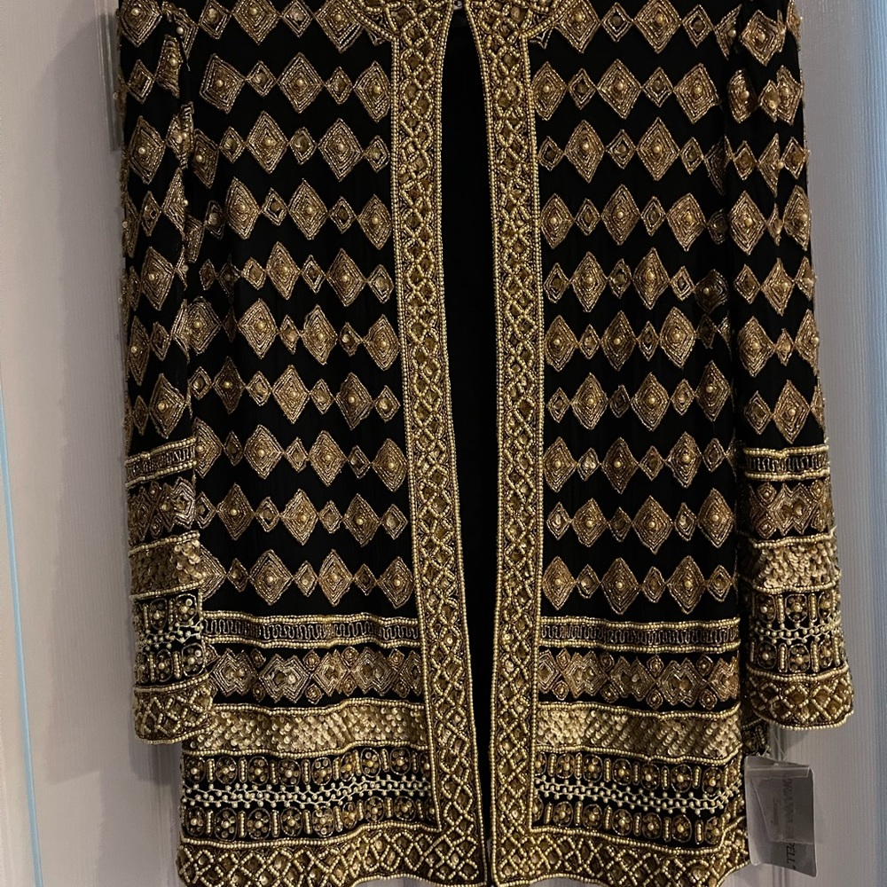 Is a brand new party blazer black with gold